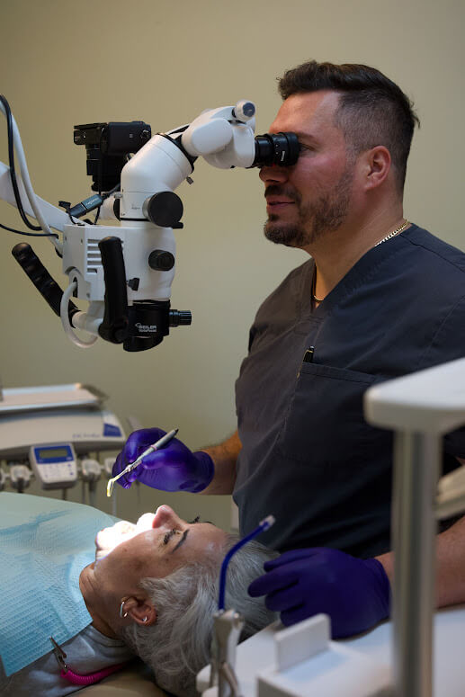 Dr. Barrero providing detailed dental care with a microscope