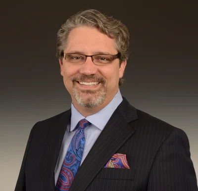 Dr. William Linger smiling in a professional portrait