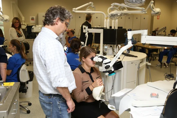Dr. Linger teaching microscope dentistry in a clinical education setting