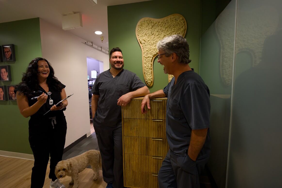 Dr. Barrero, Dr. Linger, and a team member talking in the Barrero Dental Boutique office