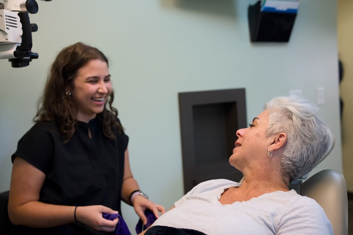 A Barrero Dental Boutique team member sharing a warm conversation with a patient